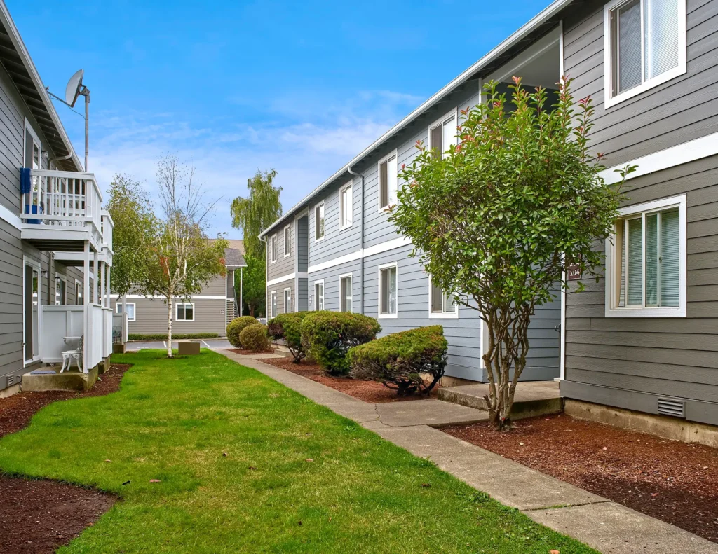 Irwin Park sidewalks and grass between community buildings.