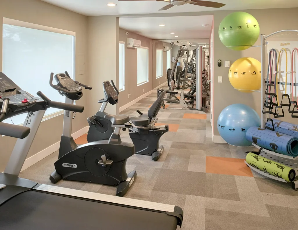 Fitness center with equipment at Irwin Park apartments for rent in Kent, WA