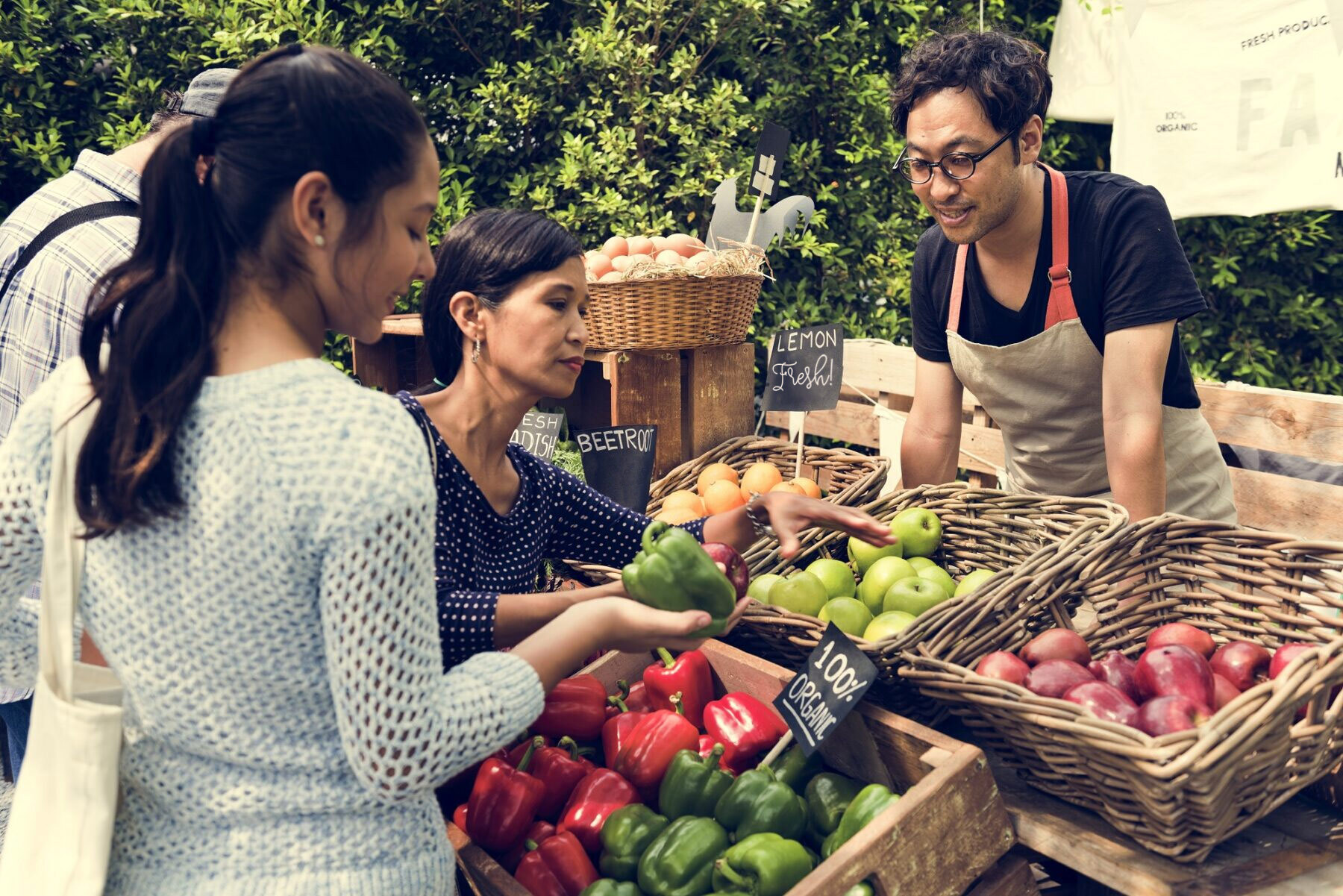 People shopping for fresh food and produce at a local farmer's market.