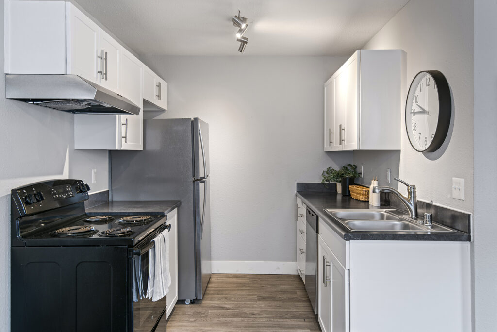 Kitchen with black counters and appliances
